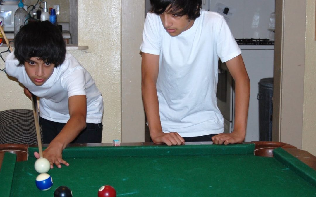 Two kids at crossfire playing pool